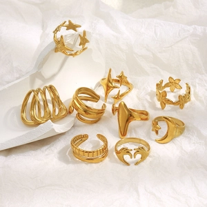 Detailed collection of gold rings featuring heart, star, and moon motifs on a stone base