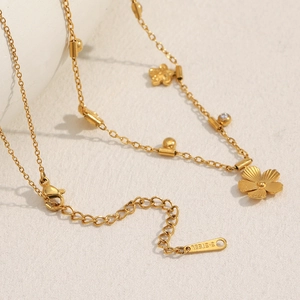 Detail of 18K gold-plated stainless steel necklace with floral charms and lobster clasp