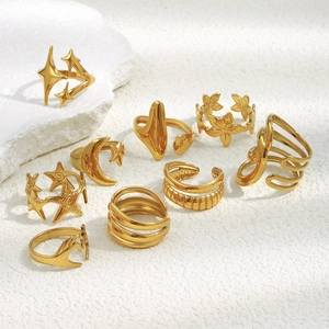 Detailed view of a 9-piece gold-plated stainless steel ring set with star and moon charms