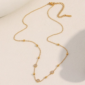 Detail of 18K gold-plated stainless steel chain with micro-pave round pendants and lobster clasp