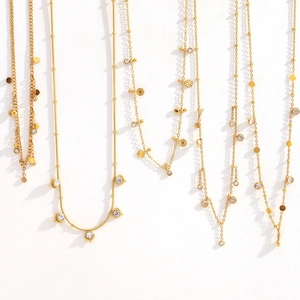 Detail view of 18K gold-plated stainless steel necklaces with zircon pendants and tassels