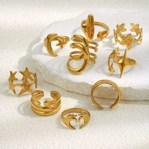 Stack of gold stainless steel rings featuring celestial star moon and heart designs