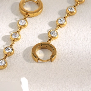 Macro shot of 18K gold plated stainless steel tassel earrings with round cubic zirconia