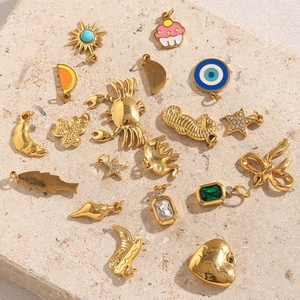 Detailed group shot of assorted 18K gold-plated charms including sea horse and starfish