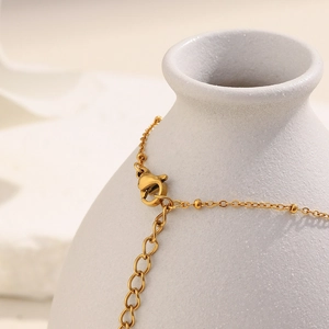 Detail of 18K gold-plated stainless steel ball chain with lobster clasp and extender