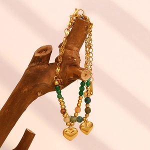 Detail of double-layer gold plated chain with colorful stone beads and heart charms