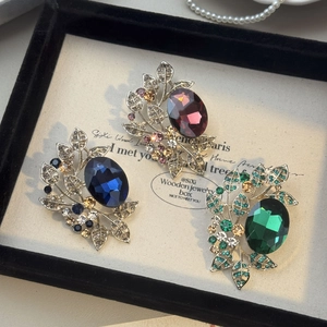 Vintage olive leaf brooches with large colorful crystals and sparkling rhinestones
