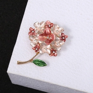Elegant hydrangea brooch with pink enamel petals and sparkling crystal centers on black backdrop