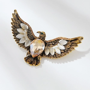 Broche aigle vintage avec cristal ambré et pierres blanches sur ailes en bronze