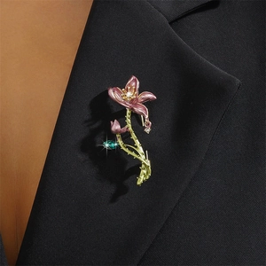 Elegant lavender enamel flower brooch with crystals pinned on a black blazer lapel