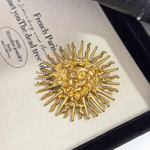 Vintage gold sun goddess relief brooch with intricate carved rays for blazer lapel decor