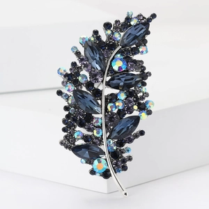 Macro shot of silver leaf brooch with deep blue crystals and shimmering rhinestones
