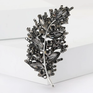 Macro shot of silver feather brooch with sparkling grey marquise crystals and rhinestones