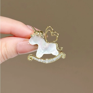 Elegant unicorn rocking horse brooch with white pearl inlay and sparkling zircon crystals