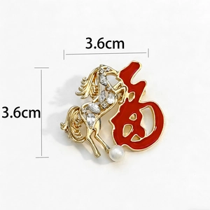 Golden horse brooch with Fu character, crystals and pearl detail on white background