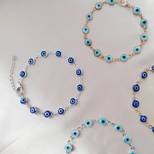 Set di braccialetti turchi Malocchio in oro e argento su sfondo in tessuto rosa