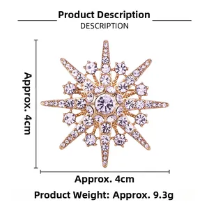 Macro detail of snowflake brooch with inlaid crystals and central diamond on golden frame