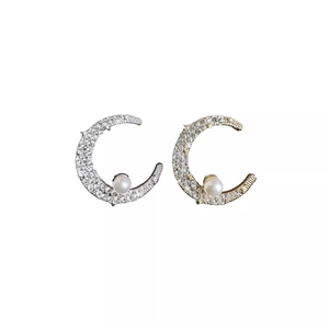 Sparkling moon pearl earrings set in silver and gold plating with micro-inlaid diamonds