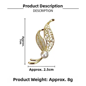 Detail view of a leaf brooch with dimensions 7cm by 2.5cm featuring pearls and crystals