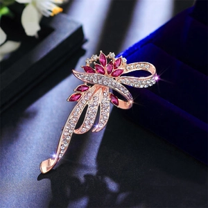 Close-up of vintage flower brooch with rose gold finish, pink marquise stones and diamonds