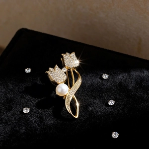 Elegant gold tulip brooch with sparkling rhinestones and a large white pearl accent