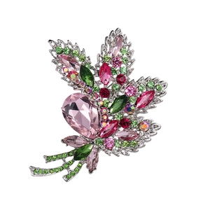 Elegant floral leaf brooch with pink and green crystals on a silver metal base