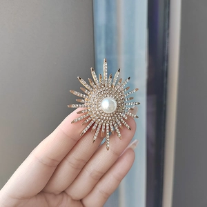 Sparkling sunburst pearl brooch with crystal pavé rays for elegant suit decoration