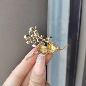 Elegant gold reindeer brooch with pearls and rhinestones shown from the back detail