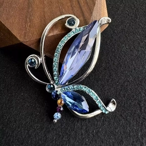 Vintage butterfly brooch with purple crystal and blue-green rhinestones on silver frame