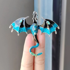 Exquisite enamel dragon brooch with sparkling crystals and blue gemstone wings