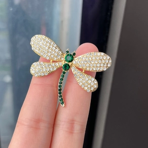 Elegant gold dragonfly brooch with white rhinestones and green gems for suits