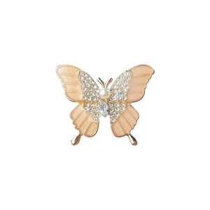 Elegant butterfly brooch with pink enamel, white pearl, and sparkling zircon accents