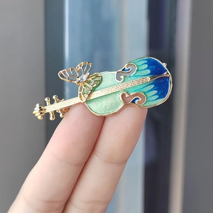 Vintage violin brooch with blue gradient enamel and crystal butterfly detail