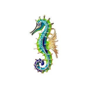 Vintage seahorse brooch with colorful enamel gradient and blue crystal inlay detail