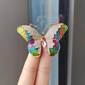 Colorful crystal butterfly brooch with sparkling stones and pink gemstone center