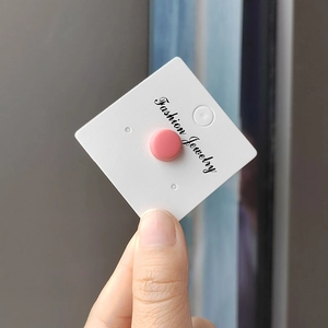 Matte pink round stud earrings displayed on white card holder with minimalist design