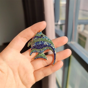 Detailed close-up of a tropical fish brooch with colorful crystals and gold plating