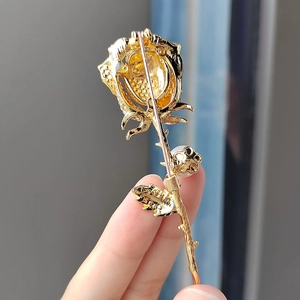 Elegant gold rose brooch with pearl detail and pin fastening for suits and coats