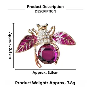 Détails d'une broche abeille avec cristaux violets et perles sur plaqué or fin