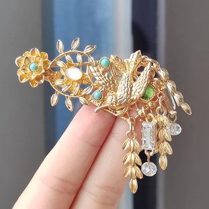 Vintage gold hummingbird brooch with flower tassels and vibrant gemstone accents
