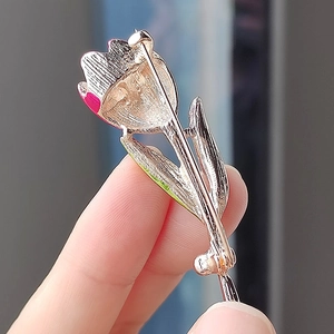 Back view of elegant tulip brooch with a secure pin clasp and gold-plated finish