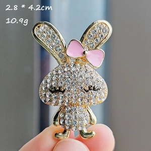 Detail of cute rabbit brooch with rhinestones and pink bow showing 2.8x4.2cm dimensions