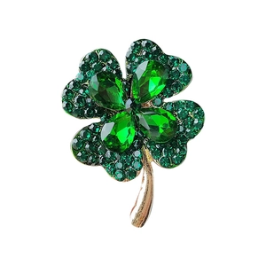 Minimalist four-leaf clover brooch with green cat-eye stones and golden finish