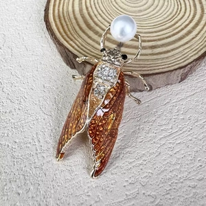 Handmade cicada brooch with brown enamel wings, sparkling rhinestones and a large white pearl