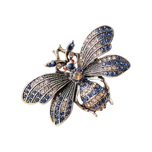 Vintage gold-tone bee brooch featuring intricate blue and champagne crystals
