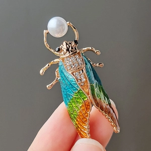 Handcrafted cicada brooch with enamel gradient wings and a pearl accent for coats