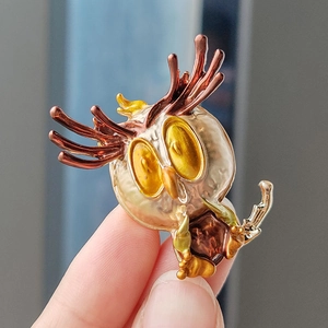 Cartoon owl brooch in colorful alloy enamel with branch antlers held in hand