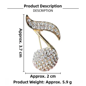 Detail showing musical note brooch in gold alloy with pavé set white rhinestones