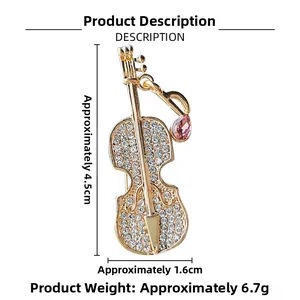 Macro detail of cello brooch with sparkling crystals and pink gemstone accents