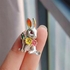 Close-up of cute rabbit brooch featuring hollow heart design and colorful enamel flowers